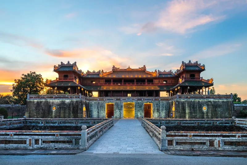 The Meridian Gate of the Hue Imperial Citadel glowing at sunset