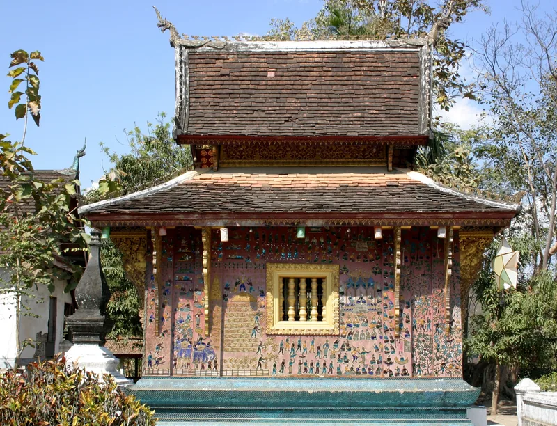 Mosaic-covered chapel with layered tiled roofs at Wat Xieng Thong, Luang Prabang
