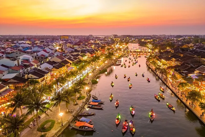 Aerial view of colorful lantern boats on the Thu Bon River in Hoi An at sunset