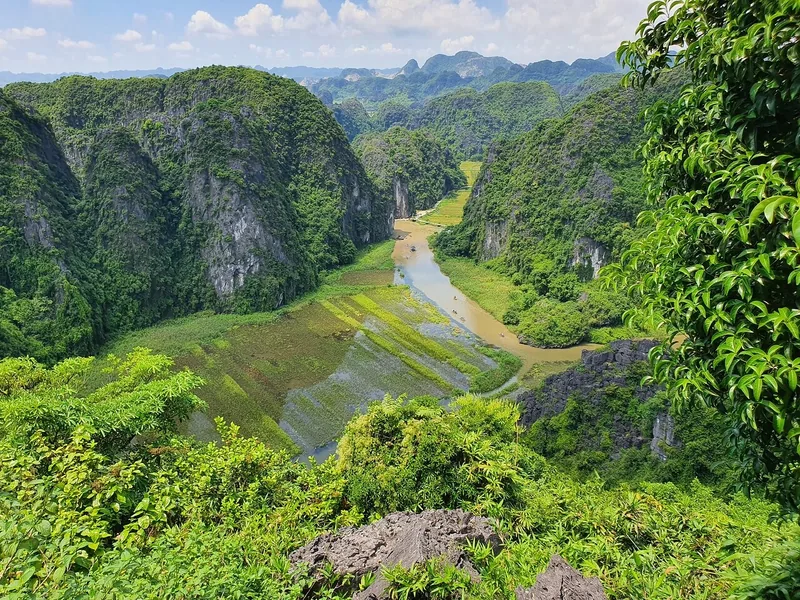Aerial view from Hang Mua viewpoint over a winding river and limestone karsts in Ninh Binh.